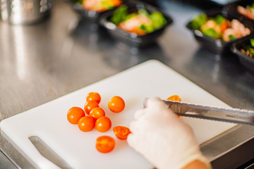 cutting an tomato in the kitchen