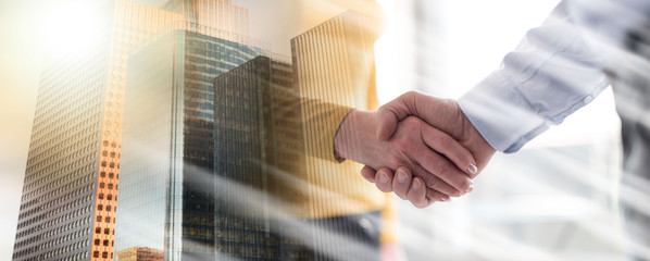 Woman and man shaking hands in office, light rays effect; multiple exposure