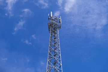 Telecommunication telephone signal transmission tower with beautiful blue sky and cloudy background