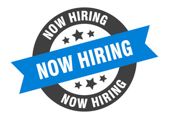 now hiring sign. now hiring blue-black round ribbon sticker