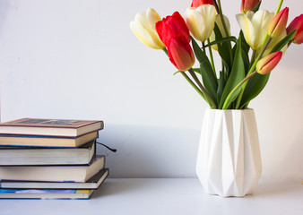 Stack of colorful books and flowers. Education background. 