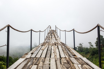 Fototapeta premium A wooden bridge over the jungle that breaks off at the end.