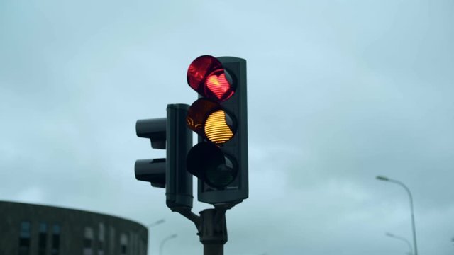 Funny and conceptual traffic light on road crossing in Akureyri, Iceland changes from red to green. The stop signal in shape of heart. Concept relationship and love