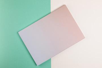 Flat lay closed book with colourful background