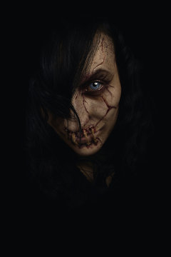 Scary female ghost with stitched mouth and scars on her face