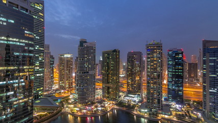 Fototapeta na wymiar Residential and office buildings in Jumeirah lake towers district day to night timelapse in Dubai