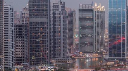 Fototapeta na wymiar Residential and office buildings in Jumeirah lake towers district day to night timelapse in Dubai