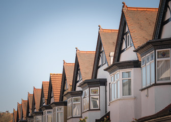 A row of typical British houses against blue sky
