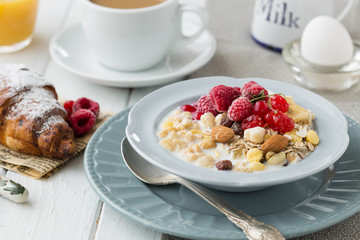 Breakfast Cereal, Table setting. Healthy tasty breakfast multigrain wholewheat healthy cereals with  raspberries, black currants and red currants.