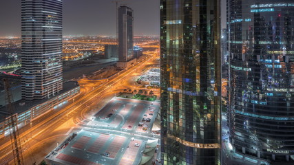 Fototapeta na wymiar Office buildings in Jumeirah lake towers district night timelapse in Dubai