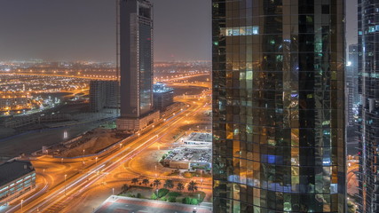Office buildings in Jumeirah lake towers district night timelapse in Dubai