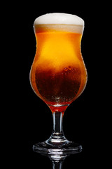 Glass of beer isolated on black background.