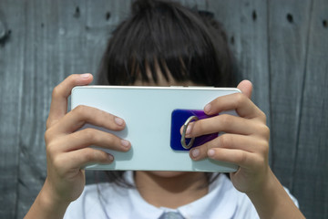 A child  playing with a smartphone