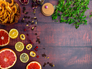 Fall and winter ingredients still life with grapefruits, lemon,cydonia, cranberries, herbs, dried apples, cinnamon sticks, spices, raisin on wooden background, antioxidants, vitamin C rich food