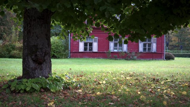 Red wooden vintage house in the park