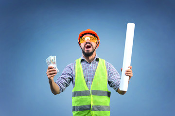 Happy yelling workman builder holding cash in right hand and completed project in left hand