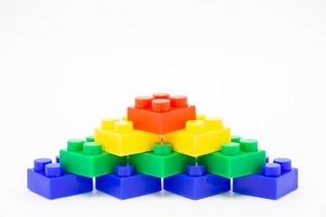 brick blocks stairs tower cubes toy mini figures colorful on white background . building plastic fun collection for child . infographic geometric template concept with white copy space.