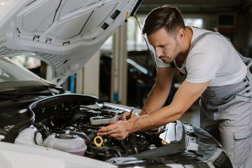 Auto mechanic working on car diagnostic in a repair shop