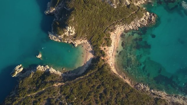 Aerial view from the popular tween beach at Corfu Island in Greece. A double-mirrored-gulf beach surrounded by vivid water in an unrealistic way