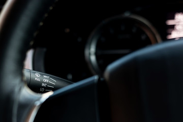 Black switch for controlling the wiper system for cars.