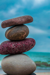 Fototapeta na wymiar Zen stones on the beach with sand and sea view