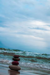 Zen stones on the beach with sand and sea view