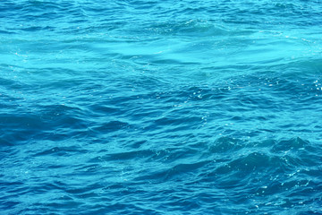 clear waving transparent blue sea water background.