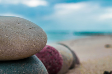 Zen stones on the beach with sand and sea view