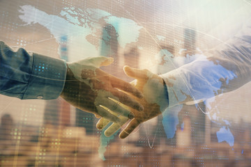 Double exposure of world map on cityscape background with two businessmen handshake. Concept of international business