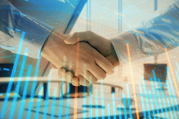 Multi exposure of financial graph on office background with two businessmen handshake. Concept of success in business