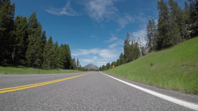 Uphill Road Toward Snow Capped Mountains