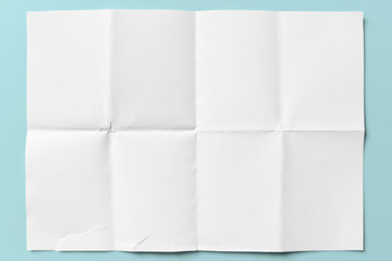 White paper folded in eight, isolated on light blue - 295312316
