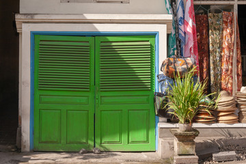 Green painted doors next to a shop, , Ubud, Bali, IDN