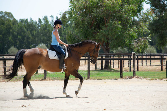 young woman galloping on a horse