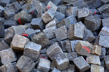 heap of Paving stones On a construction site, old cobblestones with red marker on it