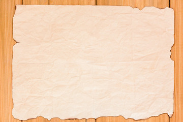 Empty blank parchment. Old paper sheet. Burnt manuscript on wood mockup.