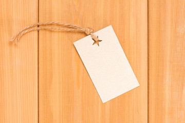 Retro cardboard Label on wood mockup. Blank tag with rope. Empty organic style sticker. Flat lay