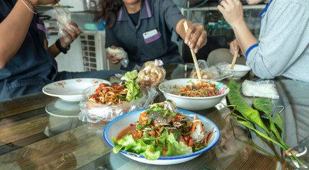 Crab salad with green vegetables placed on a glass table is the lunch of a young technician.