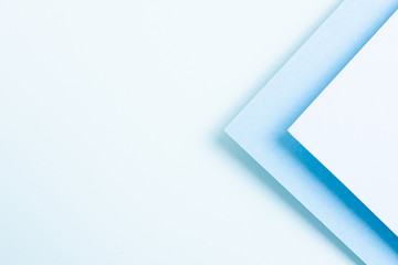 Blue toned set of triangular paper sheets with copy space
