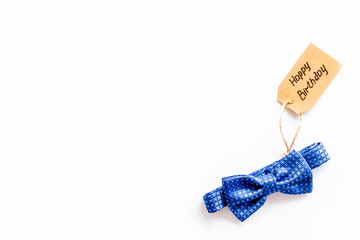 Men's birthday concept. Happy birthday text and bow tie on white background top view copy space