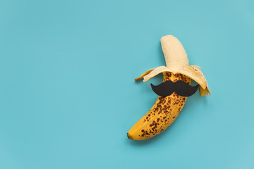 Open bad banana with black paper mustache. Sexually transmitted diseases concept.