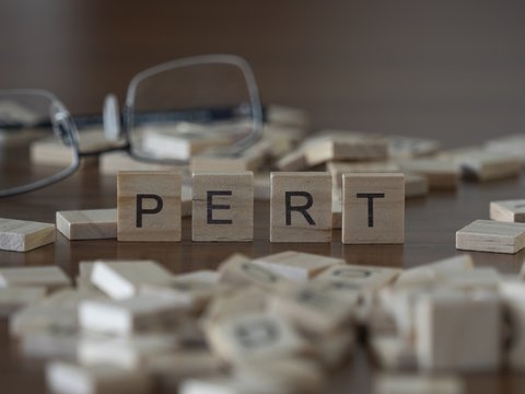 The concept of Pert represented by wooden letter tiles
