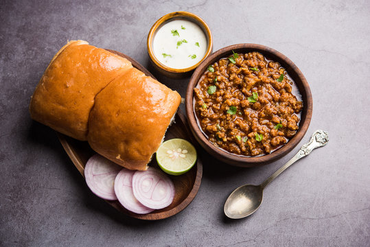 Kheema / keema Pav or Khima Paav is a spicy curry dish made up of minced chicken or lamb cooked with onion, tomatoes, served with buns. selective focus