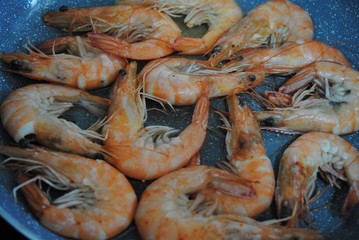 Cooking fresh seafood. Shrimp, stingray, dorado and seabass on a plate.