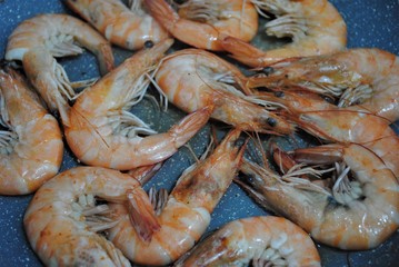 Cooking fresh seafood. Shrimp, stingray, dorado and seabass on a plate.