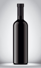 Glass black bottle on gray background