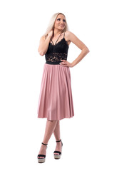 Gorgeous smiling young blonde woman in elegant classy fashion posing and looking up. Full body isolated on white background. 