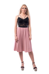 Confused blonde hair woman in elegant clothes looking away with arms down. Full body isolated on white background. 