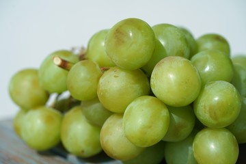 green grapes on light background