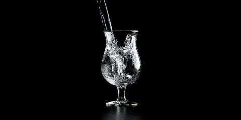 Water pouring into an elegant cocktail glass